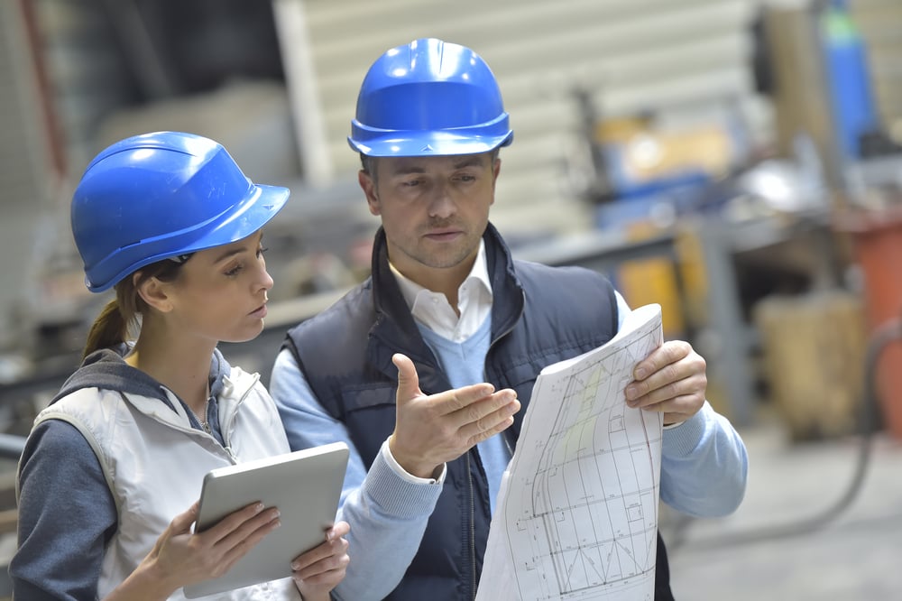 Facilities Operatives in mechanical factory reading instructions