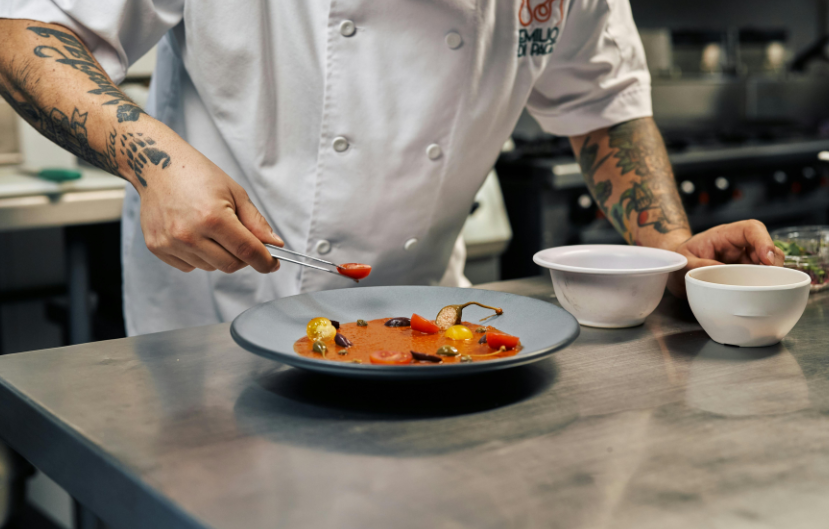 production chef in the kitchen putting together a dish