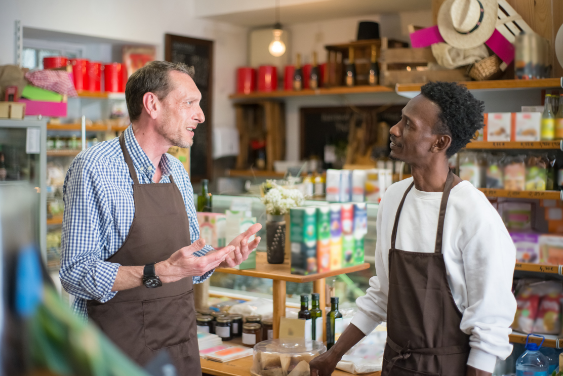 A customer speaking to a employee in a shop 