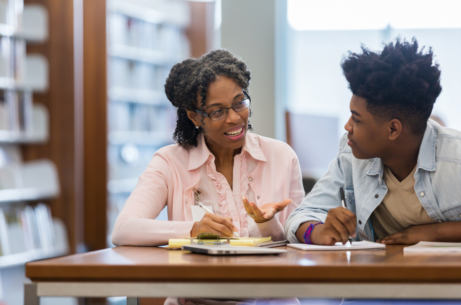 a learning & skills mentor in discussion with a learner